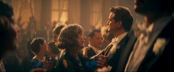 Movie still from “Magic in the Moonlight” (2014), directed by Woody Allen – An older woman and a younger man are dancing together; Medium shot, Over the shoulder angle