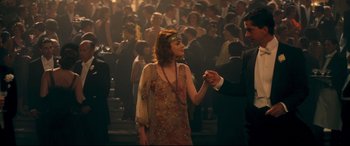 Movie still from “Magic in the Moonlight” (2014), directed by Woody Allen – A man and woman dancing in a crowd of people; Medium shot, High angle