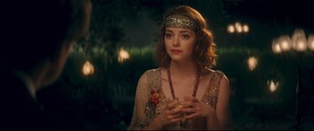 Movie still from “Magic in the Moonlight” (2014), directed by Woody Allen – A beautiful young woman wearing a head piece; Close Up shot, Over the shoulder angle