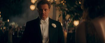 Movie still from “Magic in the Moonlight” (2014), directed by Woody Allen – A person wearing a suit and a bow tie; Medium shot, Over the shoulder angle