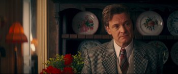 Movie still from “Magic in the Moonlight” (2014), directed by Woody Allen – A person wearing a suit and tie; Close Up shot, Over the shoulder angle