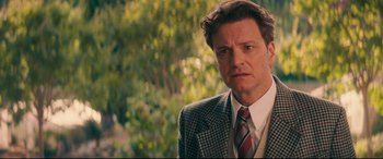 Movie still from “Magic in the Moonlight” (2014), directed by Woody Allen – A person wearing a suit and tie; Close Up shot, Over the shoulder angle