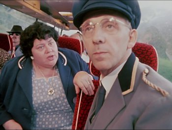 Movie still from “Magical Mystery Tour” (1967), directed by Ringo Starr – An older man and a woman on a bus; Medium shot, Over the shoulder angle