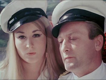 Movie still from “Magical Mystery Tour” (1967), directed by Ringo Starr – A man and a woman in sailor's hats; Close Up shot, High angle