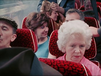 Movie still from “Magical Mystery Tour” (1967), directed by Ringo Starr – A group of people sitting on a bus; Medium shot, High angle