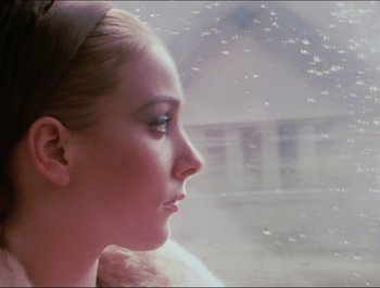 Movie still from “Magical Mystery Tour” (1967), directed by Ringo Starr – A woman looking out of a window at the rain; Close Up shot, Low angle