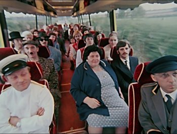 Movie still from “Magical Mystery Tour” (1967), directed by Ringo Starr – A large group of people on a public bus; Wide shot, High angle