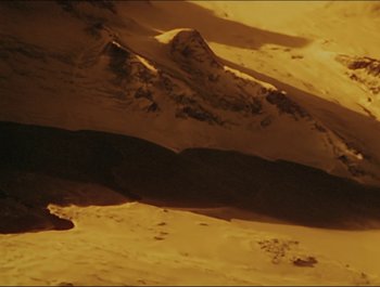 Movie still from “Magical Mystery Tour” (1967), directed by Ringo Starr – A view of a mountain range in the desert; Extreme Wide shot, High angle