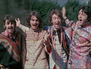 Movie still from “Magical Mystery Tour” (1967), directed by Ringo Starr – A group of people standing next to each other; Medium shot, High angle