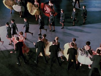 Movie still from “Magical Mystery Tour” (1967), directed by Ringo Starr – An overhead view of a group of people dressed in formal wear; Wide shot, High angle