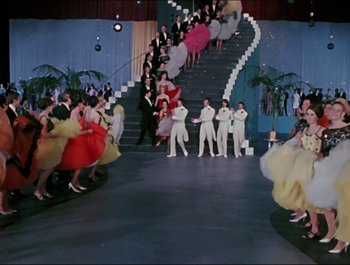 Movie still from “Magical Mystery Tour” (1967), directed by Ringo Starr – A group of people standing on top of a set of stairs; Extreme Wide shot, High angle