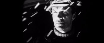 Movie still from “Magnolia” (1999), directed by Paul Thomas Anderson – A black and white photo of a man in a hat; Close Up shot, Low angle