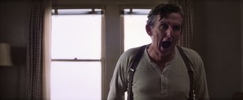 Movie still from “Magnolia” (1999), directed by Paul Thomas Anderson – A man with his mouth wide open standing in front of a window; Close Up shot, Low angle