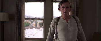 Movie still from “Magnolia” (1999), directed by Paul Thomas Anderson – An older man standing in front of a window; Close Up shot, Low angle