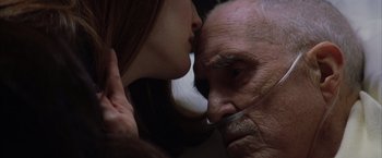 Movie still from “Magnolia” (1999), directed by Paul Thomas Anderson – An older man and a young woman kissing; Extreme Close Up shot, Low angle