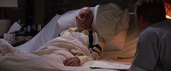 Movie still from “Magnolia” (1999), directed by Paul Thomas Anderson – An older man laying in bed with a blanket on top of him; Medium shot, High angle