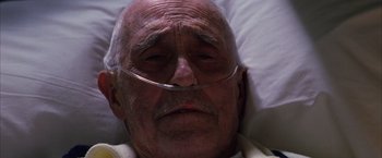 Movie still from “Magnolia” (1999), directed by Paul Thomas Anderson – An old man with a nose clip laying in a bed; Close Up shot, Low angle