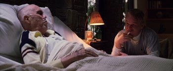 Movie still from “Magnolia” (1999), directed by Paul Thomas Anderson – An older man laying in bed next to a lamp; Medium shot, Over the shoulder angle