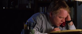 Movie still from “Magnolia” (1999), directed by Paul Thomas Anderson – A man sitting at a table with a laptop; Close Up shot, Low angle