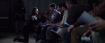 Movie still from “Magnolia” (1999), directed by Paul Thomas Anderson – A group of people sitting in a room; Wide shot, Over the shoulder angle