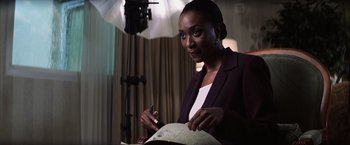 Movie still from “Magnolia” (1999), directed by Paul Thomas Anderson – A woman holding a pen and paper in her hand; Close Up shot, Low angle