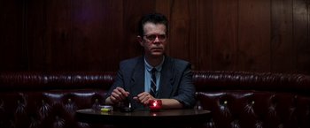 Movie still from “Magnolia” (1999), directed by Paul Thomas Anderson – A man sitting at a table with a candle in his hand; Medium shot, Low angle