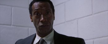 Movie still from “Magnolia” (1999), directed by Paul Thomas Anderson – A person wearing a suit and tie; Close Up shot, Low angle