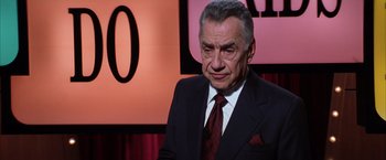 Movie still from “Magnolia” (1999), directed by Paul Thomas Anderson – An older man wearing a suit and tie; Close Up shot, Over the shoulder angle