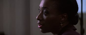 Movie still from “Magnolia” (1999), directed by Paul Thomas Anderson – A woman's face in the dark; Close Up shot, Over the shoulder angle