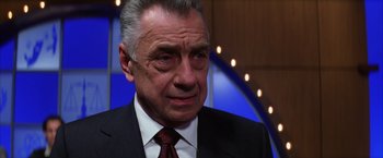 Movie still from “Magnolia” (1999), directed by Paul Thomas Anderson – An older man wearing a suit and tie; Close Up shot, Low angle