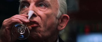 Movie still from “Magnolia” (1999), directed by Paul Thomas Anderson – An older man with a white beard is holding a piece of paper in front of his face; Extreme Close Up shot, Low angle