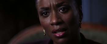 Movie still from “Magnolia” (1999), directed by Paul Thomas Anderson – A woman's face with her eyes wide open; Close Up shot, Over the shoulder angle