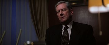 Movie still from “Magnolia” (1999), directed by Paul Thomas Anderson – An older man in a suit and tie looking into the distance; Close Up shot, Over the shoulder angle