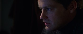 Movie still from “Magnolia” (1999), directed by Paul Thomas Anderson – A man's face in the dark; Close Up shot, Over the shoulder angle