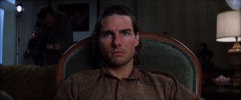 Movie still from “Magnolia” (1999), directed by Paul Thomas Anderson – A person sitting in a chair; Close Up shot, Low angle