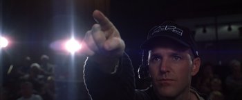Movie still from “Magnolia” (1999), directed by Paul Thomas Anderson – A man in a black hat is holding a flashlight; Close Up shot, Low angle