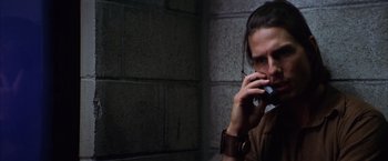 Movie still from “Magnolia” (1999), directed by Paul Thomas Anderson – A man in a brown shirt talking on a cell phone; Close Up shot, High angle