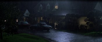 Movie still from “Magnolia” (1999), directed by Paul Thomas Anderson – A car parked in the rain in front of a house; Extreme Wide shot, High angle