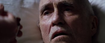 Movie still from “Magnolia” (1999), directed by Paul Thomas Anderson – An old man with a beard and a white mustache; Extreme Close Up shot, High angle
