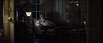 Movie still from “Magnolia” (1999), directed by Paul Thomas Anderson – An older man sitting in a chair in a living room; Medium shot, High angle