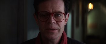 Movie still from “Magnolia” (1999), directed by Paul Thomas Anderson – A person wearing glasses and a scarf; Close Up shot, Low angle