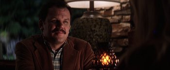 Movie still from “Magnolia” (1999), directed by Paul Thomas Anderson – A person sitting in a room; Close Up shot, Low angle