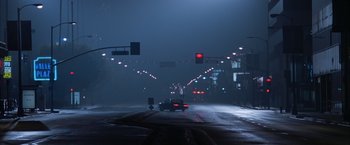 Movie still from “Magnolia” (1999), directed by Paul Thomas Anderson – A car driving down a street at night in the rain; Extreme Wide shot, Low angle