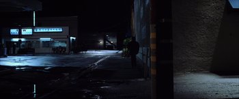Movie still from “Magnolia” (1999), directed by Paul Thomas Anderson – A person walking down a street at night; Wide shot, Low angle