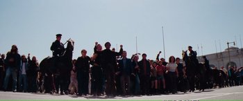 Movie still from “Magnum Force” (1973), directed by Ted Post – A group of people standing in front of a crowd; Wide shot, High angle