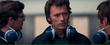 Movie still from “Magnum Force” (1973), directed by Ted Post – A person wearing headphones; Close Up shot, Over the shoulder angle