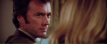 Movie still from “Magnum Force” (1973), directed by Ted Post – A man's face with a blurry background; Close Up shot, Over the shoulder angle