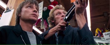 Movie still from “Magnum Force” (1973), directed by Ted Post – A man holding a gun up to his face; Close Up shot, Low angle