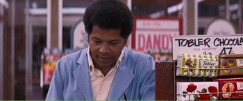 Movie still from “Magnum Force” (1973), directed by Ted Post – A man in a blue jacket is sitting down; Medium shot, Over the shoulder angle