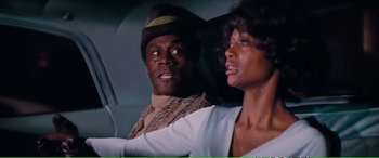 Movie still from “Magnum Force” (1973), directed by Ted Post – A man and a woman in the back seat of a car; Close Up shot, Over the shoulder angle